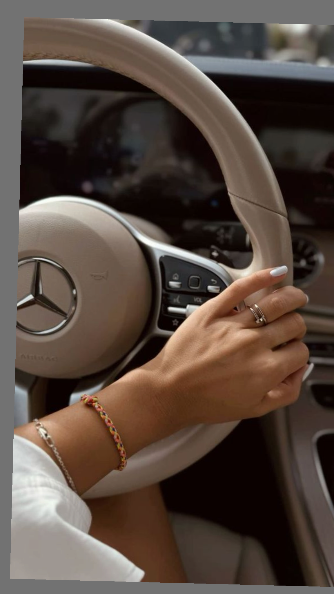 Hand on a dream car steering wheel